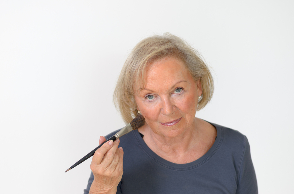 older woman with makeup brush.jpg
